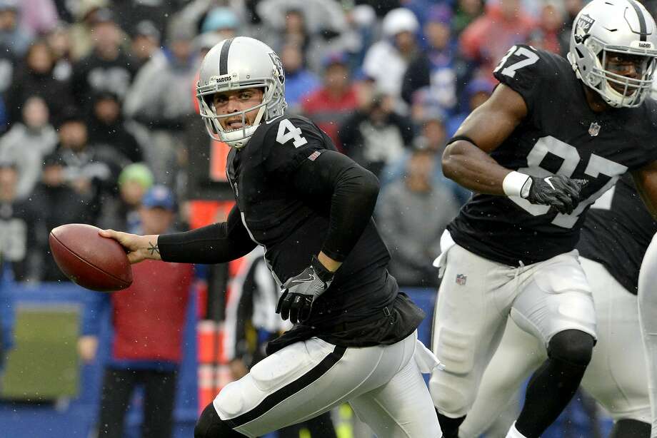 Oakland Raiders quarterback Derek Carr rolls out after faking a handoff during the first half of an NFL football game against the Buffalo Bills, Sunday, Oct. 29, 2017, in Orchard Park, N.J. (AP Photo/Adrian Kraus) Photo: Adrian Kraus, Associated Press